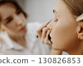 Make-up artist at work. Applying make-up to model face. 130826853