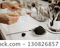 Makeup artist takes foundation from her desk 130826857