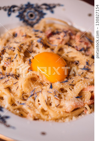 Noodles plate. Tasty macaroni. Traditional pasta cooked with grated cheese raw egg yolk. Italian cuisine carbonara recipe for delicious dinner. Noodles plate. Tasty macaroni. Traditional pasta cooked with grated cheese raw egg yolk. Italian cuisine carbonara recipe for delicious dinner. 130827154