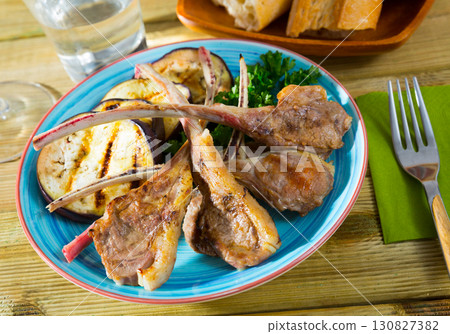 Image of tasty grilled with eggplants lamb ribs, served with greens 130827382