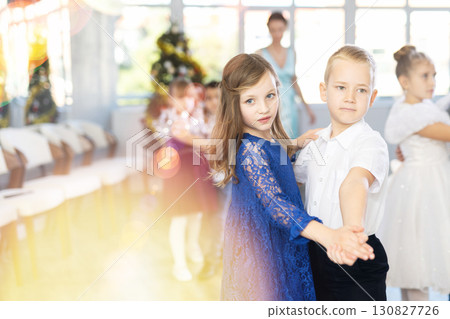 Tween boy and girl performing waltz during Christmas event at school Tween boy and girl performing waltz during Christmas event at school 130827726