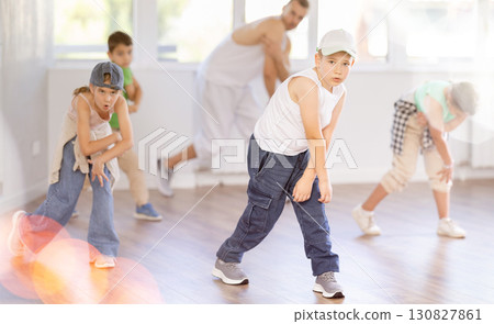 Emotional happy teen boy dancing hip hop with group of friends in dance studio. Concept hip-hop generation Emotional happy teen boy dancing hip hop with group of friends in dance studio. Concept hip-hop generation 130827861