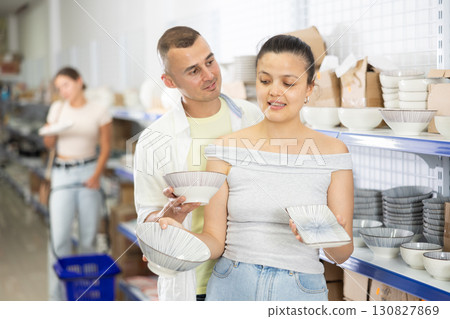 Couple man and woman choosing plate 130827869
