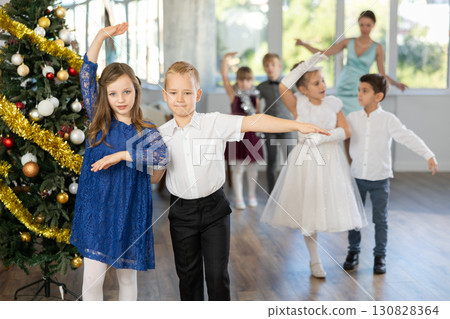 Tween boy and girl performing waltz during Christmas event at school 130828364