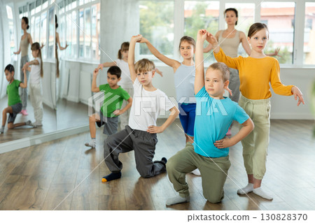 Happy preteen children practicing ballroom dances in pairs in training hall 130828370