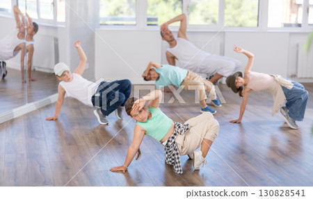 Preteen girl performing hip hop during group dance class 130828541