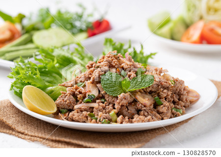 Local Thai food, Spicy minced pork salad (Larb Moo) eating with fresh vegetables on white background 130828570