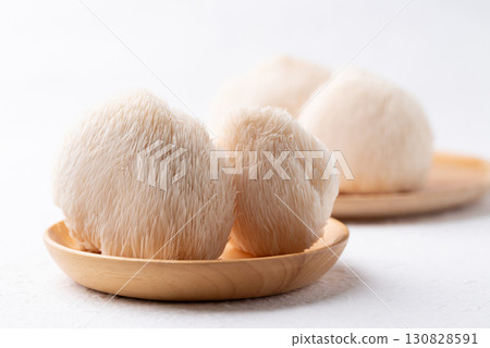 Lion's Mane mushroom or Yamabushitake mushroom on wooden plate 130828591