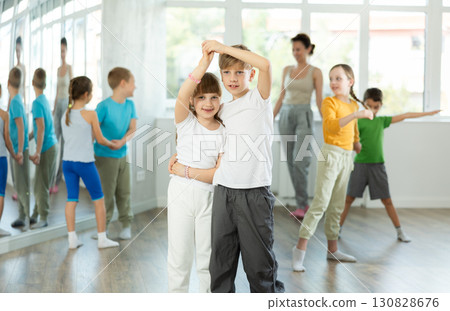Preteen girls and boys learn to dance classical dances in choreographic studio 130828676