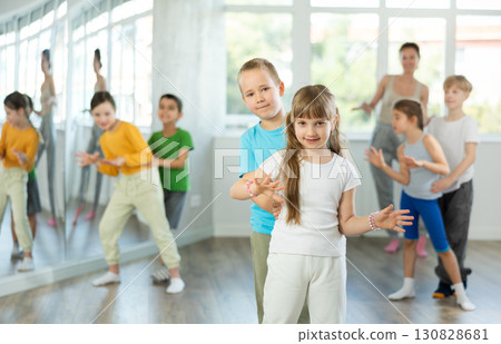 Girl paired up with boy and training to perform boogie woogie couple dance, rehearse performance. 130828681