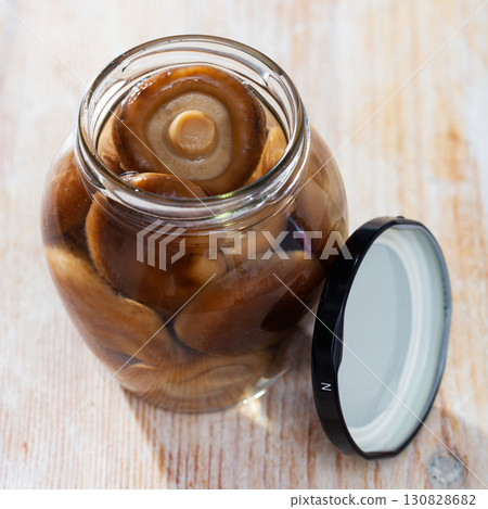 Open glass jar with natural shiitake mushrooms 130828682