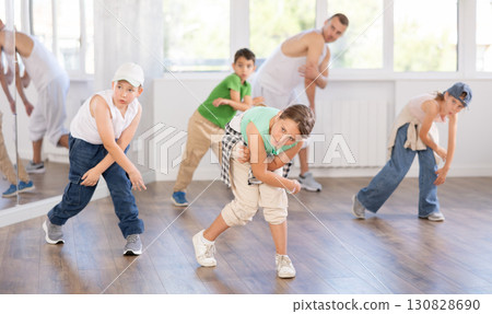 Tween girl dancer rehearsing krump dance at group workout Tween girl dancer rehearsing krump dance at group workout 130828690