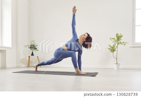 Yogi beautiful woman in elegant sportswear enjoying doing yoga exercise 130828739