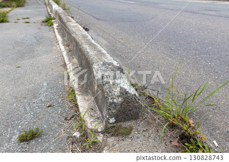 Damaged sidewalk/road boundary block 130828743