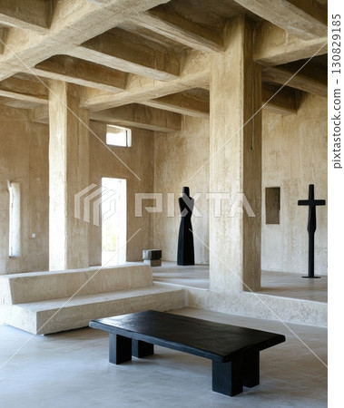 Interior View Of Concrete Structure With Geometric Pillars and Black Furniture and Sculptures 130829185