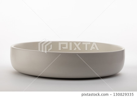 a simple, shallow, light-colored bowl designed to hold food or other small items a simple, shallow, light-colored bowl designed to hold food or other small items 130829335