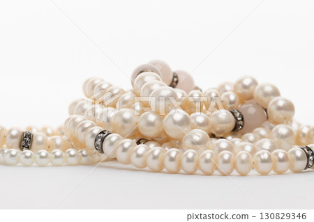 Bunch of white pearls glistening under light Bunch of white pearls glistening under light 130829346