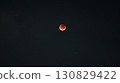 A total lunar eclipse floating in the night sky 130829422