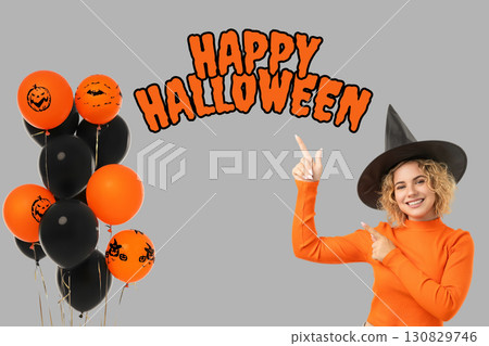 Woman in orange sweater points excitedly at Halloween balloons Woman in orange sweater points excitedly at Halloween balloons 130829746