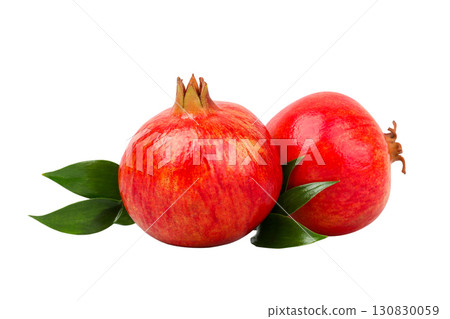Two ripe pomegranates with red skin and green leaves, isolated, PNG 130830059