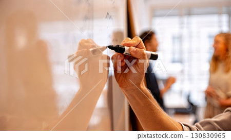 A person presenting a report on a whiteboard. Business analysis, data, planning, strategy 130830965