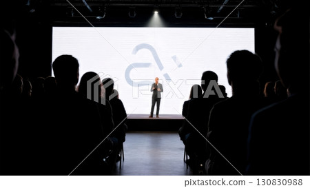 A dynamic shot of a speaker on a stage. Business presentation, keynote speech, thought leadership A dynamic shot of a speaker on a stage. Business presentation, keynote speech, thought leadership 130830988