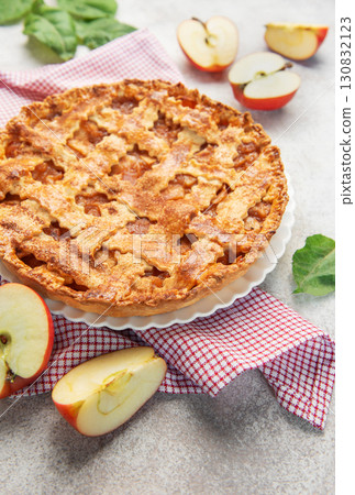Delicious homemade apple pie decorated with fresh apple slices and leaves Delicious homemade apple pie decorated with fresh apple slices and leaves 130832123