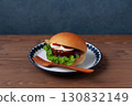 Teriyaki burger on a plate on a wooden table 130832149