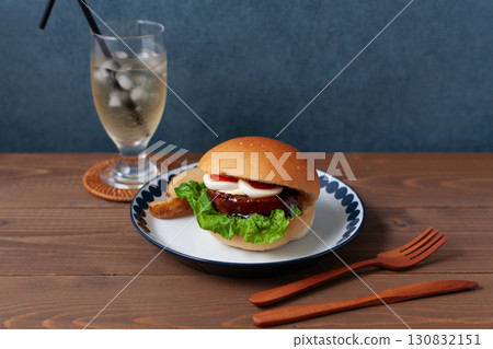 Teriyaki burger on a plate on a wooden table Teriyaki burger on a plate on a wooden table 130832151