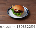 Teriyaki burger on a plate on a wooden table 130832254