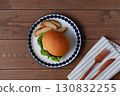 Teriyaki burger on a plate on a wooden table 130832255
