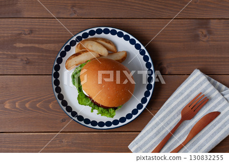 Teriyaki burger on a plate on a wooden table 130832255