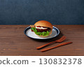 Teriyaki burger on a plate on a wooden table 130832378