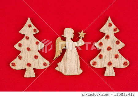 Wooden angel and fir trees 130832412