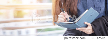 Banner Businesswoman hands writing on notebook meeting agenda in conference room. Banner Woman Hands writing office paper. Female hand holding pencil working Personal Organizer with copy space Banner Businesswoman hands writing on notebook meeting agenda in conference room. Banner Woman Hands writing office paper. Female hand holding pencil working Personal Organizer with copy space 130832504