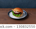 Teriyaki burger on a plate on a wooden table 130832550