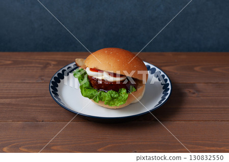 Teriyaki burger on a plate on a wooden table 130832550