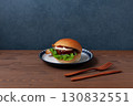 Teriyaki burger on a plate on a wooden table 130832551