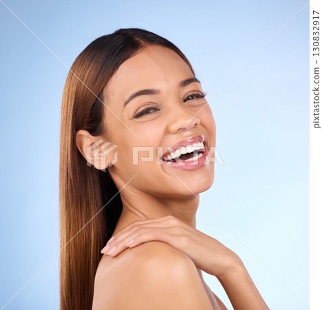 Skincare, hand on shoulder and portrait of woman laughing in studio, skin care on blue background. Makeup, facial detox cosmetics and smile on face, hispanic model with natural beauty for dermatology 130832917