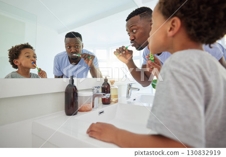 Learning, brushing teeth and father with son in bathroom for dental, morning routine and cleaning. Teaching, self care and toothbrush with black man and child at home for wellness, fresh and hygiene Learning, brushing teeth and father with son in bathroom for dental, morning routine and cleaning. Teaching, self care and toothbrush with black man and child at home for wellness, fresh and hygiene 130832919