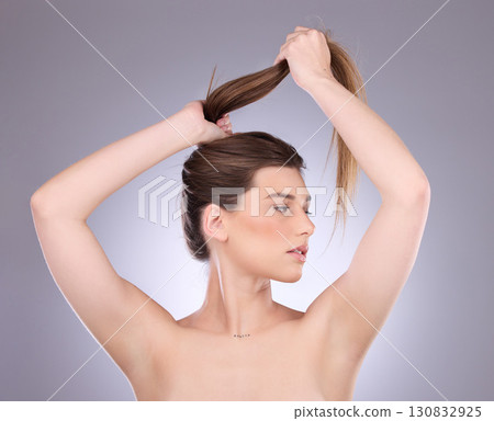 Thinking, beauty and hair care of a woman in studio isolated on a gray background. Cosmetics, growth and female model with salon treatment for healthy keratin, balayage texture or long hairstyle pull Thinking, beauty and hair care of a woman in studio isolated on a gray background. Cosmetics, growth and female model with salon treatment for healthy keratin, balayage texture or long hairstyle pull 130832925