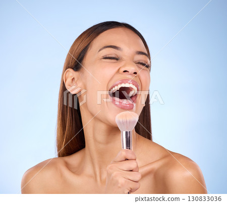 Skincare, beauty and woman with brush, makeup and happiness against blue studio background. Female, lady and cosmetics tool with laugh, foundation and natural skin glow with joy, cheerful and facial Skincare, beauty and woman with brush, makeup and happiness against blue studio background. Female, lady and cosmetics tool with laugh, foundation and natural skin glow with joy, cheerful and facial 130833036