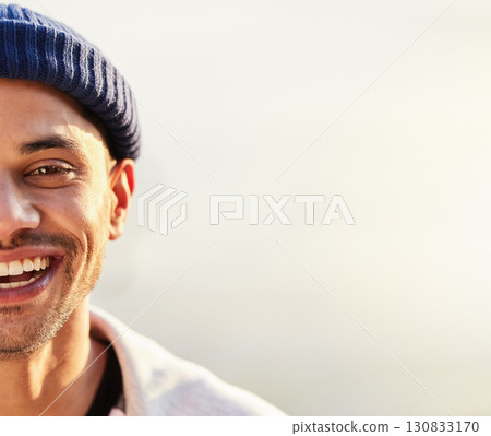 Half, face and happy man with mockup space by hipster with a fashionable beanie on a simmer day with a smile. Guy, cool and side head of a stylish young male looking confident and excited 130833170
