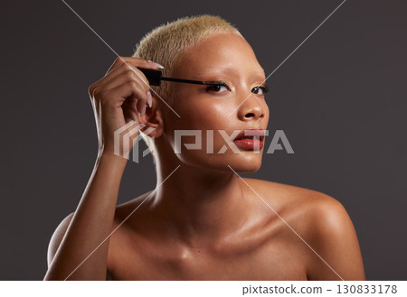 Makeup, mirror and portrait of woman with mascara in studio for cosmetics, beauty products and skincare. Salon aesthetic, cosmetology and face of girl with brush for eyelashes, application and luxury 130833178