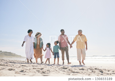 Grandparents, parents and children walking on beach holding hands for love, support and quality time together. Travel, happy and kids with big family by ocean for holiday, summer vacation and weekend 130833189