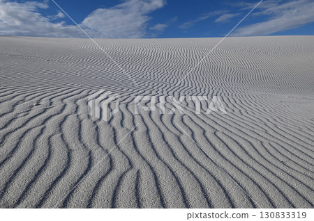 Wind ripples carved into the white sand 130833319