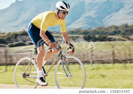 Man cycling with blurred speed in nature, countryside and training for triathlon, sports and power. Cyclist, bicycle and motion of bike for fitness, energy and freedom on mountain path in sunshine Man cycling with blurred speed in nature, countryside and training for triathlon, sports and power. Cyclist, bicycle and motion of bike for fitness, energy and freedom on mountain path in sunshine 130833397