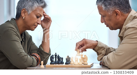 Strategy, moving and thinking with old couple and chess for bonding, competition and mental exercise. Relax, problem solving and smart with man and woman at home for board games, checkmate or contest Strategy, moving and thinking with old couple and chess for bonding, competition and mental exercise. Relax, problem solving and smart with man and woman at home for board games, checkmate or contest 130833409