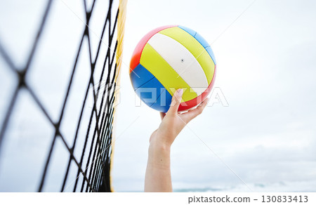 Hands, fitness and beach net volleyball with woman scoring goals in competition, game or match. Sports, training and female athlete holding ball in tournament to score for exercise or workout outdoor 130833413