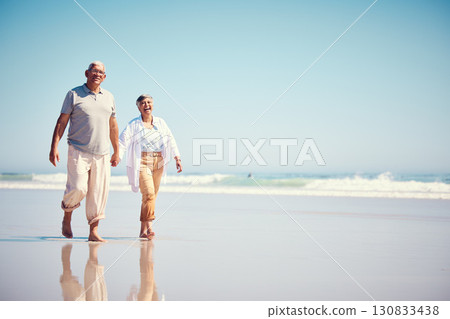 Holding hands, summer and an old couple walking on the beach with a blue sky mockup background. Love, romance or mock up with a senior man and woman taking a walk on the sand by the ocean or sea Holding hands, summer and an old couple walking on the beach with a blue sky mockup background. Love, romance or mock up with a senior man and woman taking a walk on the sand by the ocean or sea 130833438